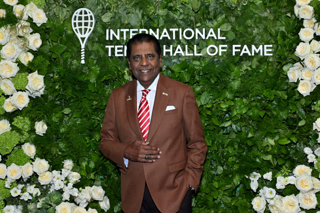 Vijay Amritraj poses in front of the Tennis Hall of Fame sign