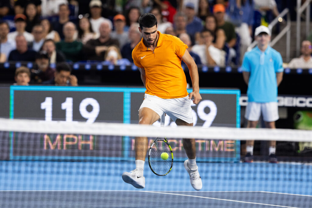 Carlos Alcaraz of Spain returns a shot through his legs during his singles match at the Miami Invitational at loanDepot Park in Miami, Florida, on December 8, 2025.