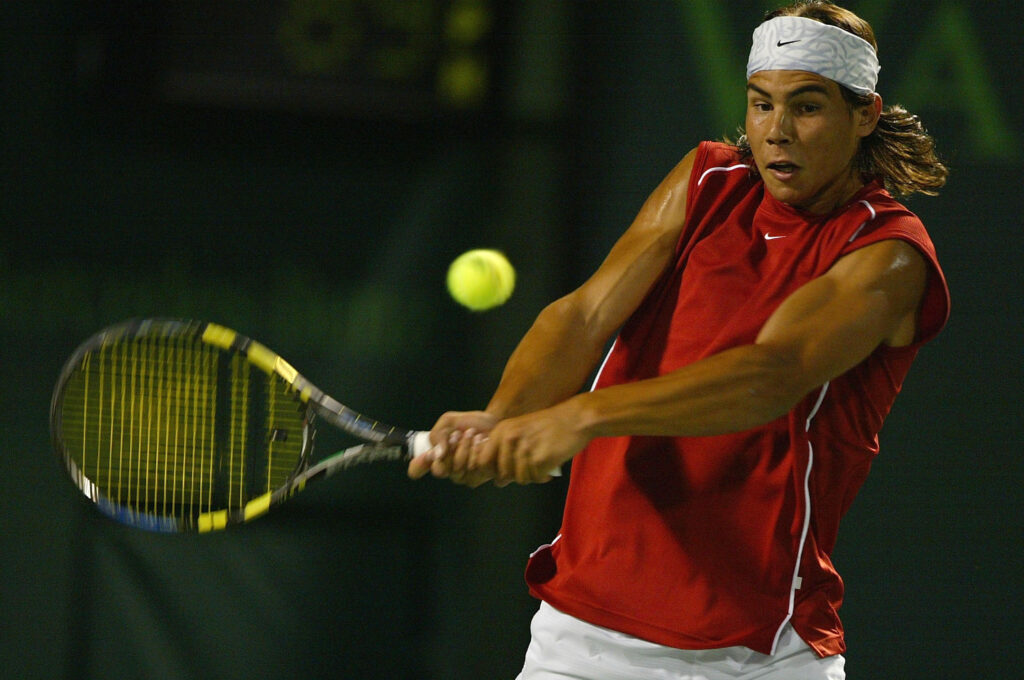 Rafael Nadal of Spain plays a backhand against Roger Federer of Switzerland during The third round of Nasdaq 100 Open on March 28, 2004 in Miami, Florida.