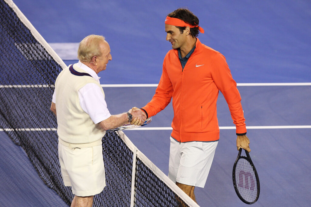 Roger Federer of Switzerland (R) and Australian tennis legend Rod Laver shake hands during the Roger Federer Charity match at Melbourne Park on January 8, 2014 in Melbourne, Australia.