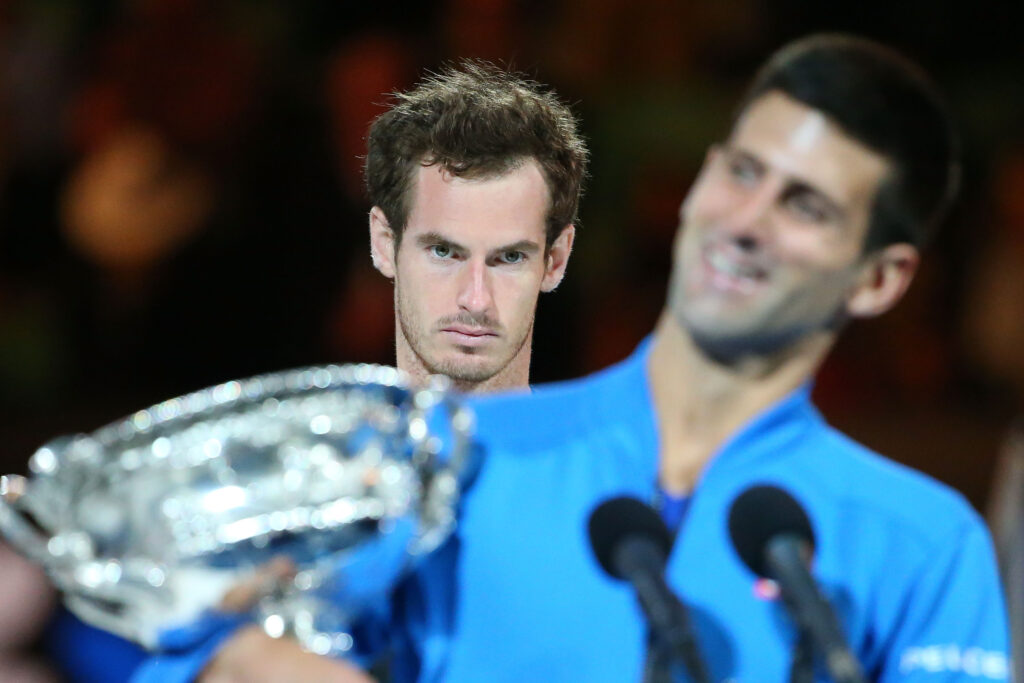 Andy Murray of Great Britain looks on as Novak Djokovic of Serbia holds the Norman Brookes Challenge Cup after he won their men's final match during day 14 of the 2015 Australian Open at Melbourne Park on February 1, 2015 in Melbourne, Australia.