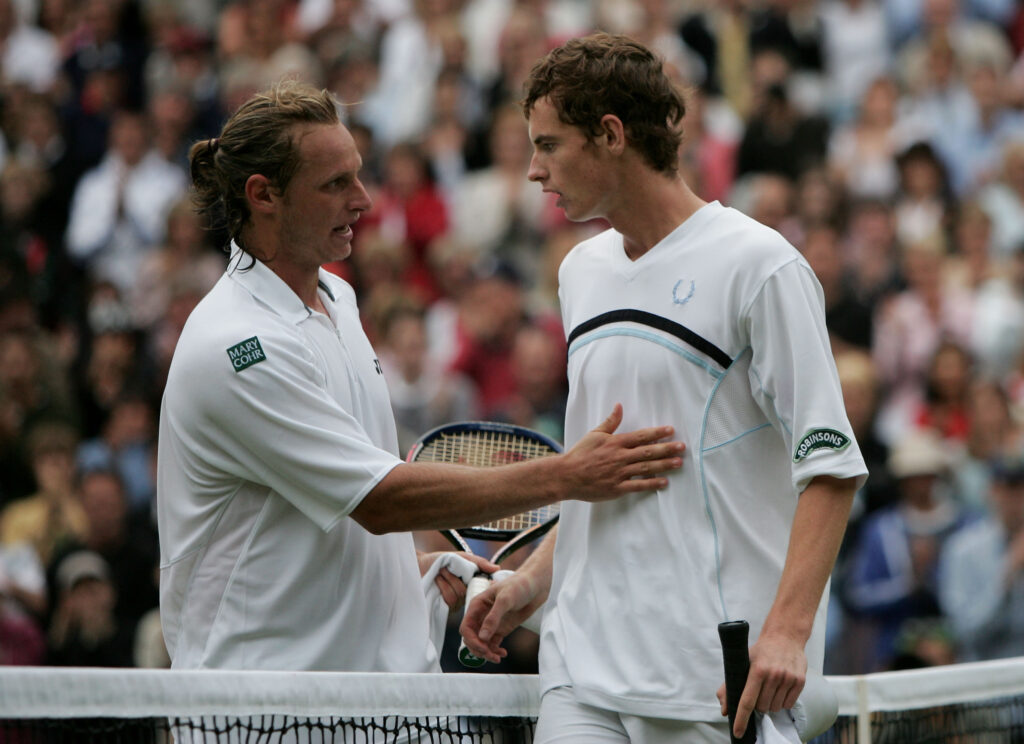Andrew Murray of Great Britain with David Nalbandian of Argentina after Murray lost in five sets during the sixth day of the Wimbledon Lawn Tennis Championship on June 25, 2005 at the All England Lawn Tennis and Croquet Club in London.