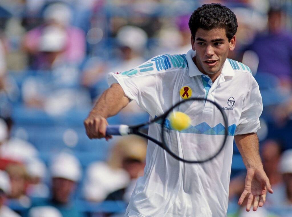 Pete Sampras of the United States makes a back hand return to Jim Courier during their Men's Singles Semi Final match of the United States Open Tennis Championship on 11 September 1992 at the USTA National Tennis Center in New York