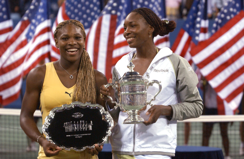 Venus Williams holds her trophy with her sister Serena Williams after the women's final match of the US Open at the USTA National Tennis Center in Flushing, New York. Venus defeats Serena 6-2, 6-4.
