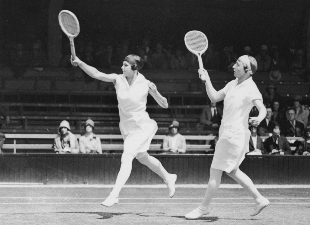 Australian tennis players Daphne Akhurst Cozens (1903 - 1933, left) and Esna Boyd (1901 - 1962) during the ladies' doubles at Wimbledon, 1928.