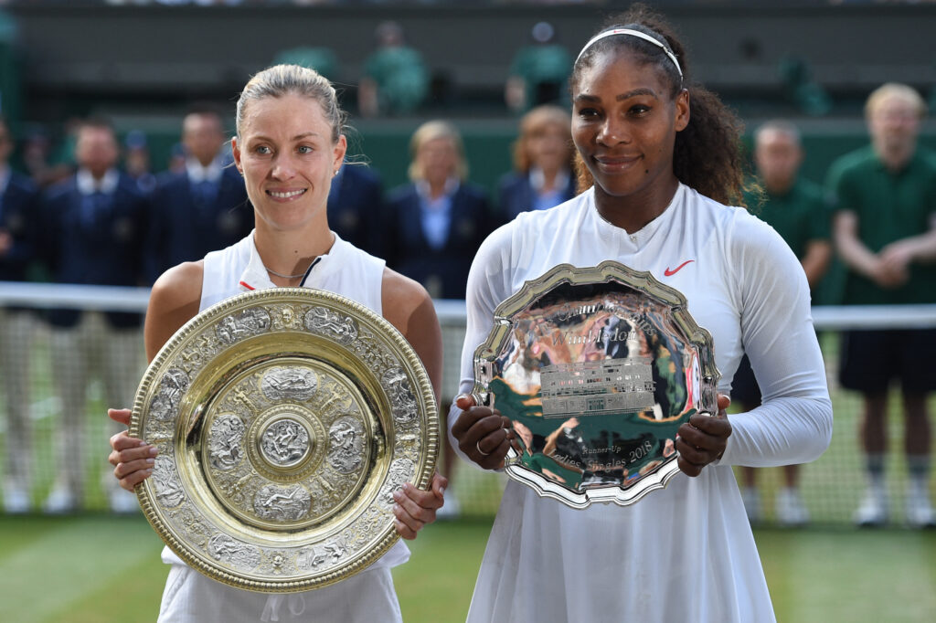 Germany's Angelique Kerber (L) holds the winner's trophy, the Venus Rosewater Dish, after her women's singles final victory over US player Serena Williams on the twelfth day of the 2018 Wimbledon Championships at The All England Lawn Tennis Club in Wimbledon, southwest London, on July 14, 2018.