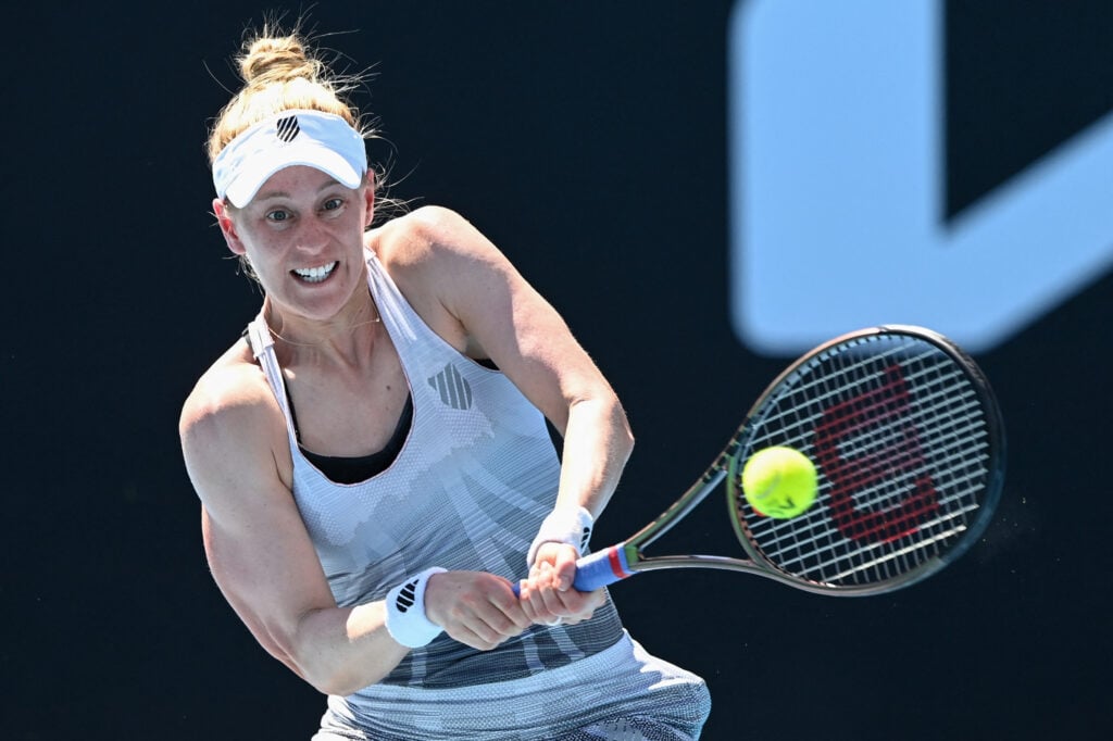 Alison Riske of the US hits a return against Latvia's Jelena Ostapenko during their women's singles match on day three of the Australian Open tennis tournament in Melbourne on January 19, 2022.