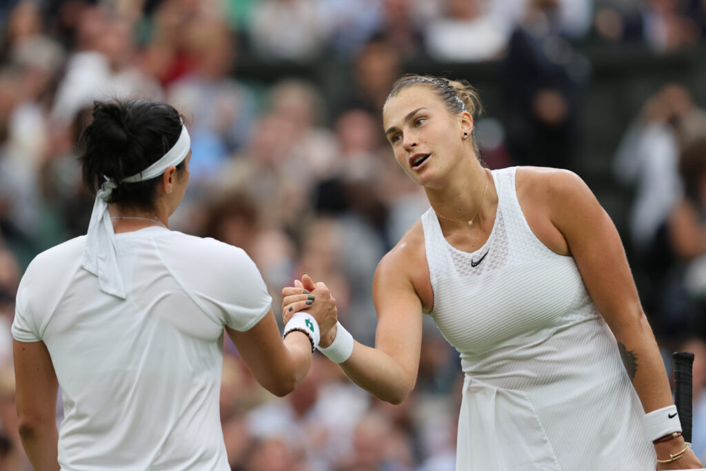 Aryna Sabalenka of Belarus and Ons Jabeur of Tunisia shake hands at the net after their Ladies' Singles Quarter-Final match during Day Eight of The Championships - Wimbledon 2021 at All England Lawn Tennis and Croquet Club on July 06, 2021 in London, England.