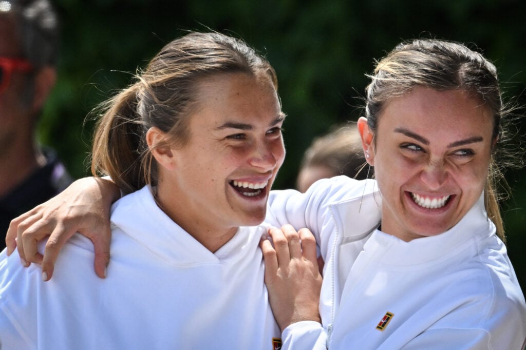 Belarus's Aryna Sabalenka (L) and Spain's Paula Badosa (R) laugh together before a training session prior to the start of the 2023 Wimbledon Championships at The All England Tennis Club in Wimbledon, southwest London, on July 2, 2023.