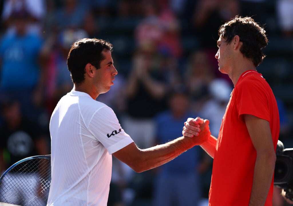 Taylor Fritz of the United States shakes hands at the net after his three set victory against Jaume Munar of Spain in their third round match on Day 9 of the BNP Paribas Open at the Indian Wells Tennis Garden on March 15, 2022 in Indian Wells, California.