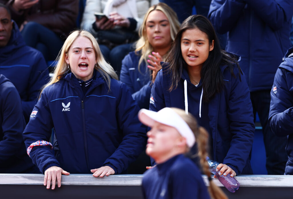 Sonay Kartal and Emma Raducanu of Great Britain support teammate Harriet Dart of Great Britain during day two of the Billie Jean King Cup Play-Off match between the Czech Republic and Great Britain at the Tennis Club 1. CLTK Prague on April 16, 2022 in Prague, Czech Republic.
