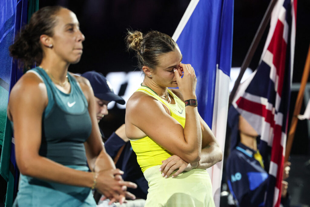Winner Madison Keys of the US (L) and Belarus' Aryna Sabalenka are seen during the podium ceremony following their women's singles final match on day fourteen of the Australian Open tennis tournament in Melbourne on January 25, 2025.