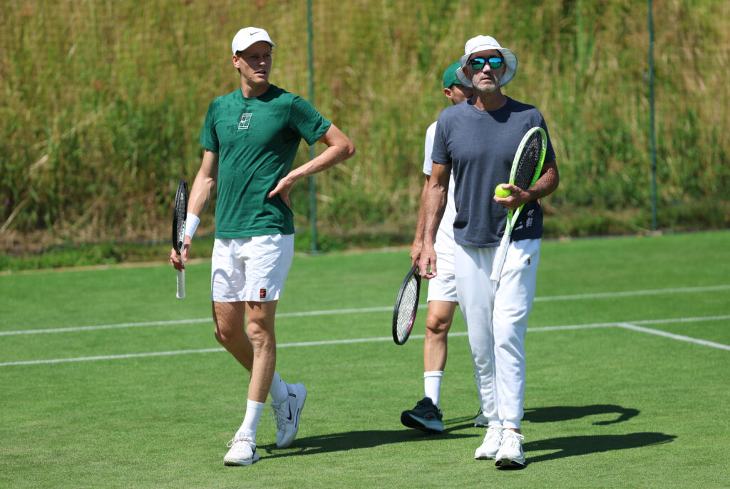 Jannik Sinner of Italy looks on with his coach, Darren Cahill, during a practice session prior to The Championships Wimbledon 2025 at All England Lawn Tennis and Croquet Club on June 27, 2025 in London, England.