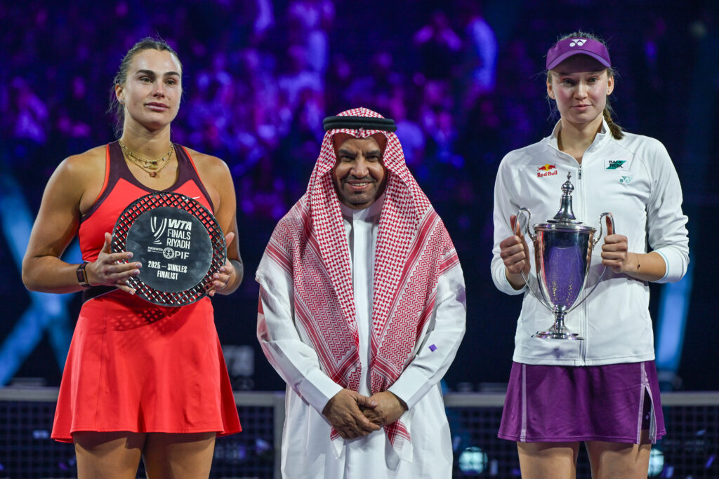 Runner-up Aryna Sabalenka, Mohammed Alsarah, President of the Saudi Tennis Federation, and champion Elena Rybakina of Kazakhstan pose during the trophy ceremony following the singles final on Day 8 of the 2025 WTA Finals, part of the Hologic WTA Tour, at King Saud University Indoor Arena in Riyadh, Saudi Arabia.