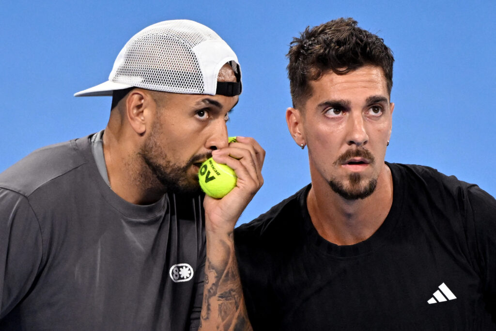 Nick Kyrgios (L) and Thanasi Kokkinakis (R) of Australia discuss tactics during their men's doubles match against Matthew Ebden of Australia and Rajeev Ram of the US at the Brisbane International tennis tournament in Brisbane on January 4, 2026.