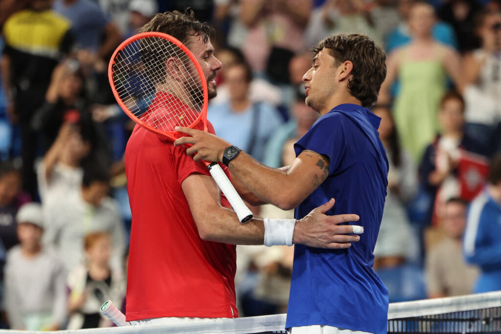 Italy's Flavio Cobolli (R) is congratulated by Switzerland's Stan Wawrinka after his win at their men's singles match during the United Cup tennis tournament in Perth on January 4, 2026.