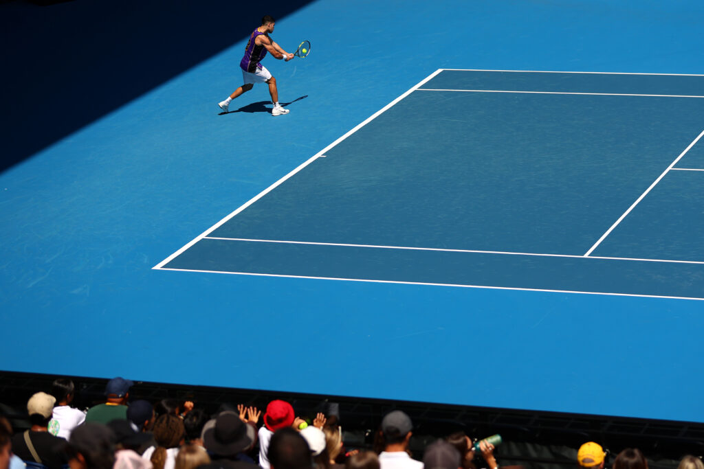 Carlos Alcaraz of Spain plays a backhand during a practice session as spectators watch ahead of the 2026 Australian Open at Melbourne Park on January 12, 2026 in Melbourne, Australia.