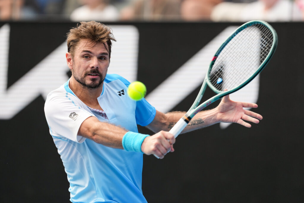 Stan Wawrinka of Switzerland plays a backhand in the Men's Singles First Round match against Laslo Djere of Serbia during day two of the 2026 Australian Open at Melbourne Park on January 19, 2026 in Melbourne, Australia.