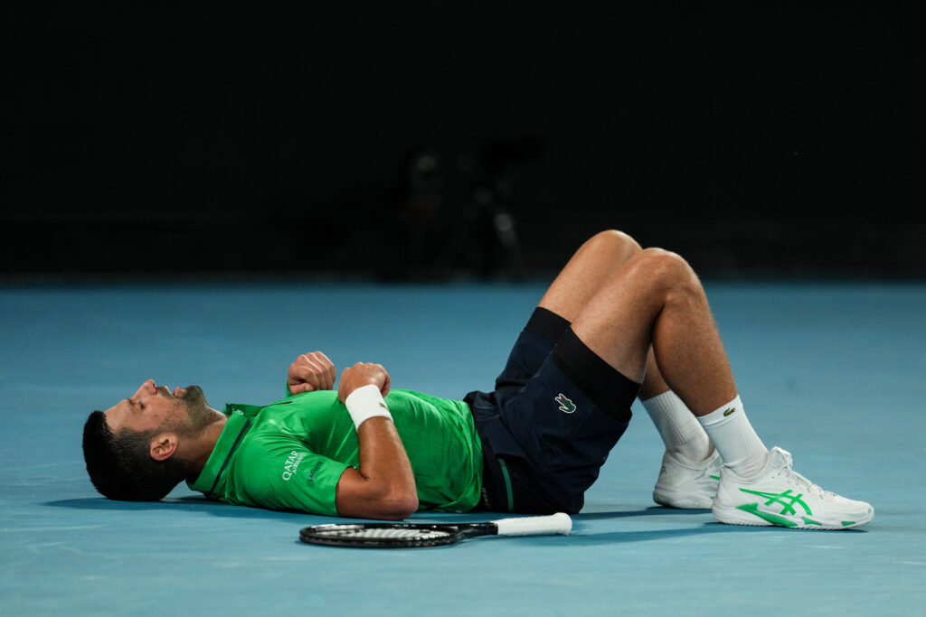 Novak Djokovic lies on the court