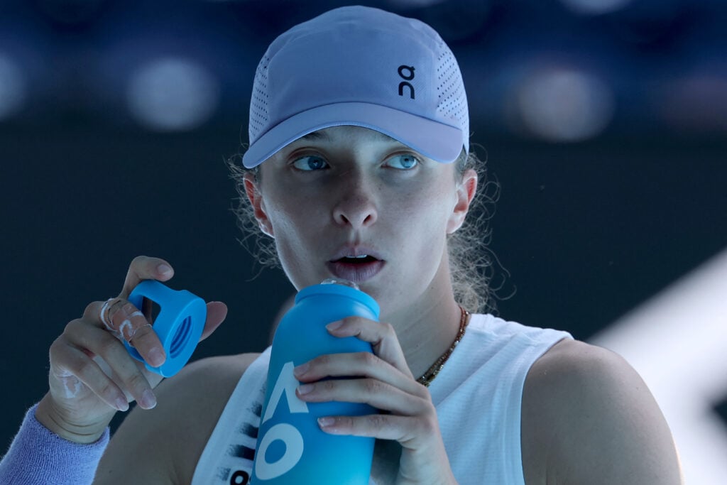 Poland's Iga Swiatek drinks water after the first set against Kazakhstan's Elena Rybakina during their women's singles quarter-final match on day eleven of the Australian Open tennis tournament in Melbourne on January 28, 2026.