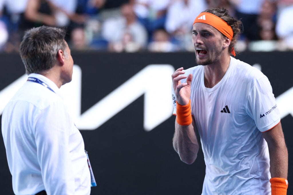 Germany's Alexander Zverev speaks with a match official during his men's singles semi-final match against Spain's Carlos Alcaraz on day thirteen of the Australian Open tennis tournament in Melbourne on January 30, 2026.