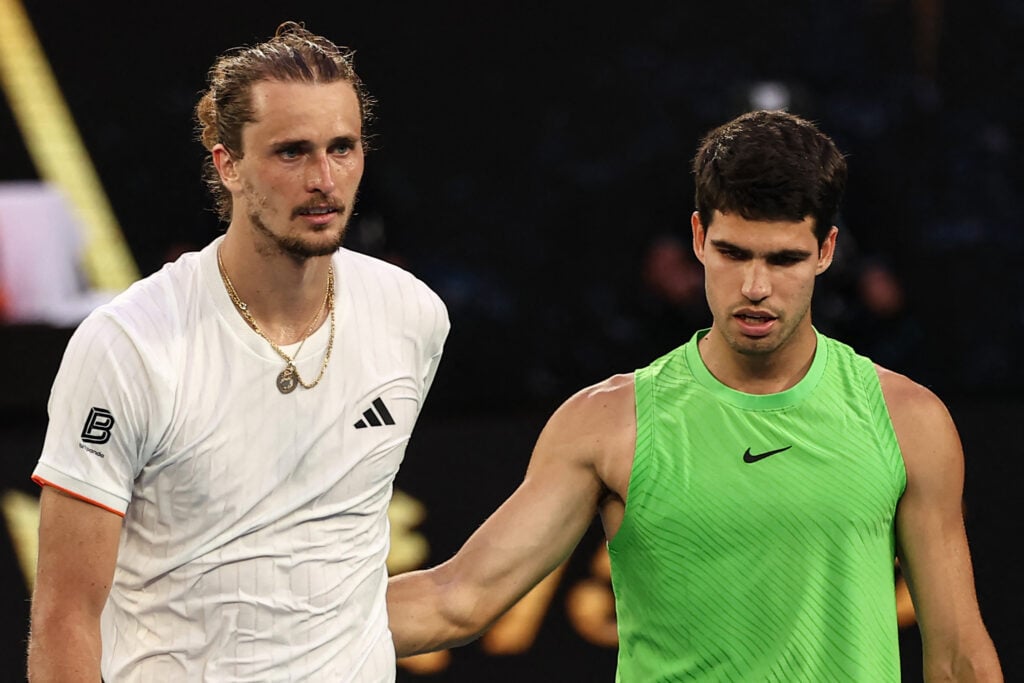 Spain's Carlos Alcaraz greets Germany's Alexander Zverev after winning their men's singles semi-final match on day thirteen of the Australian Open tennis tournament in Melbourne on January 30, 2026.