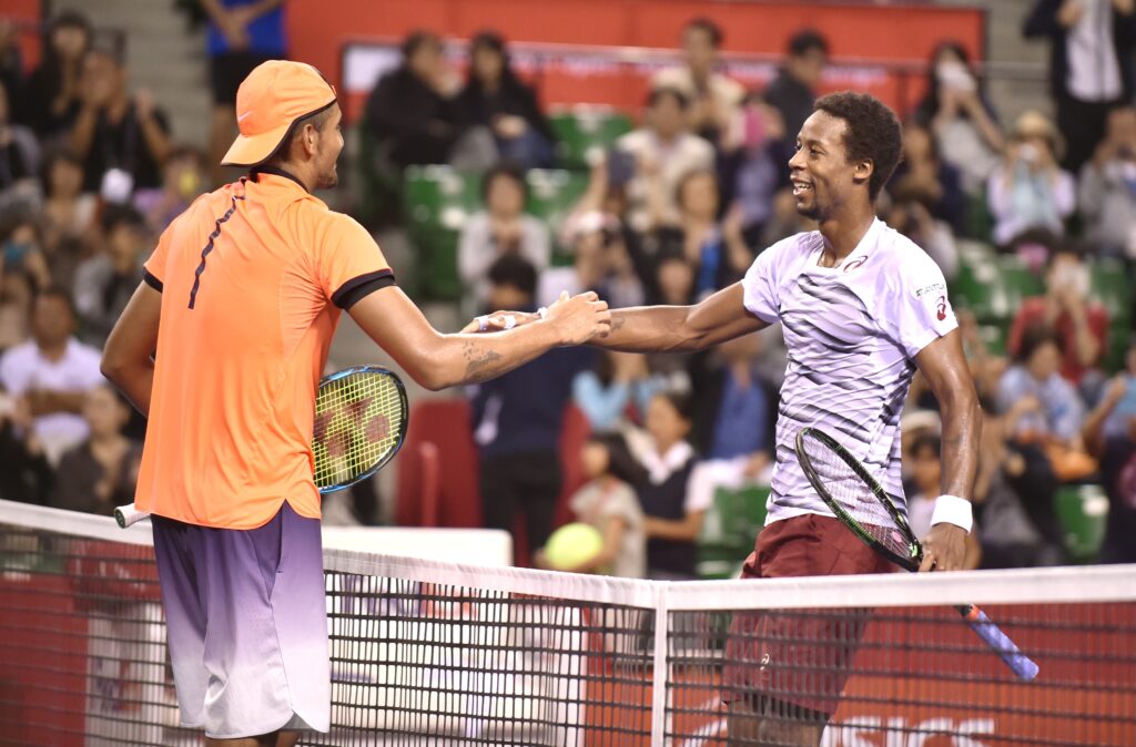 Australia's Nick Kyrgios (L) is congratulated by France's Gael Monfils (R) after his victory in their men's singles semi-final match at the ATP Japan Open tennis tournament in Tokyo on October 8, 2016.