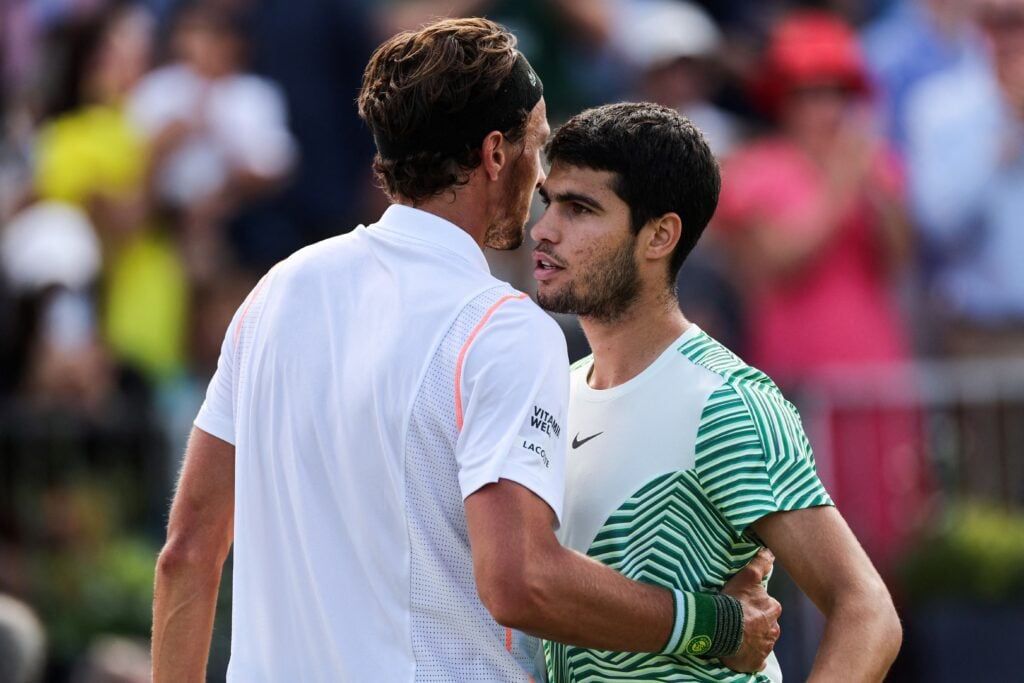 Spain's Carlos Alcaraz (R) is congratulated by France's Arthur Rinderknech after winning their men's single tennis match on Day 4 of the Cinch ATP tennis Championships at Queen's Club in west London, on June 20, 2023.