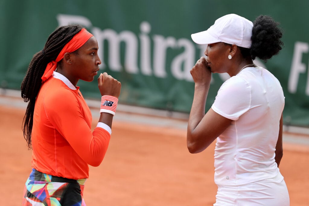 Coco Gauff (L) and Venus Williams of The United States react during their women's first round match against Siasai Zheng of China and Ellen Perez of Australia during day four of the 2021 French Open at Roland Garros on June 02, 2021 in Paris, France.