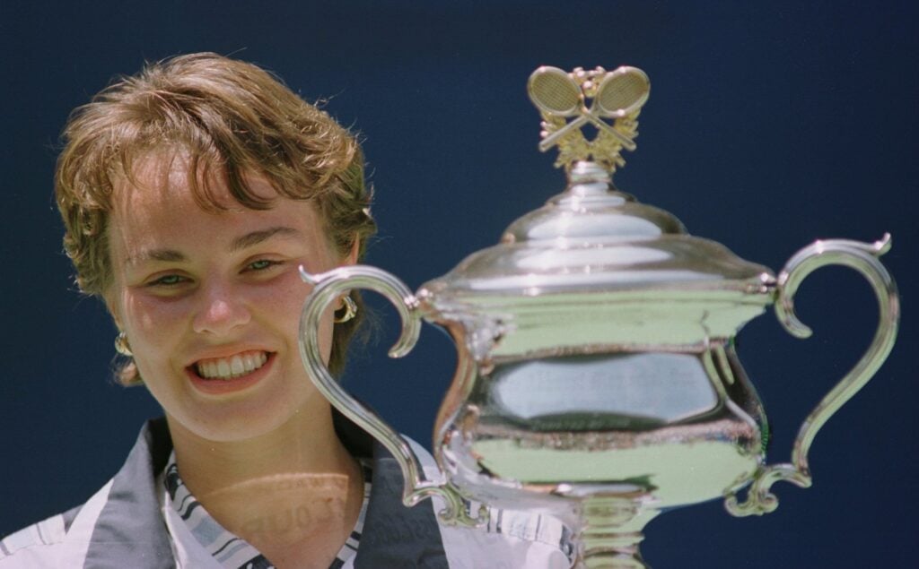 Martina Hingis of Switzerland poses with the trophy after defeating Mary Pierce of France to win the Ladies final of the Ford Australian Open at Melbourne in Melbourne, Australia.