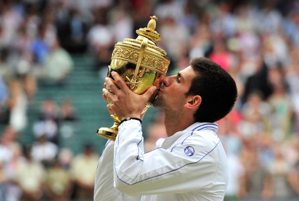 Serbian player Novak Djokovic kisses the trophy after beating Spanish player Rafael Nadal in the men's single final at the Wimbledon Tennis Championships at the All England Tennis Club, in southwest London on July 3, 2011. Djokovic won 6-4, 6-1, 1-6, 6-3.
