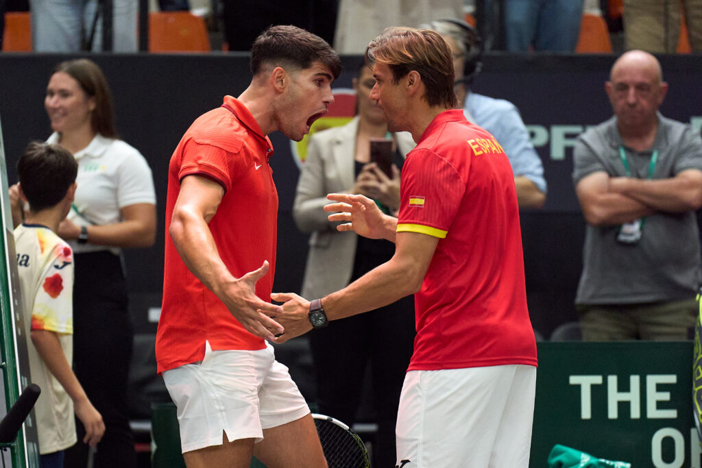 Carlos Alcaraz and Captain David Ferrer of Spain celebrate victory against Ugo Humbert of France during the 2024 Davis Cup Finals Group Stage match between France and Spain at Pabellon Fuente De San Luis on September 13, 2024 in Valencia, Spain.