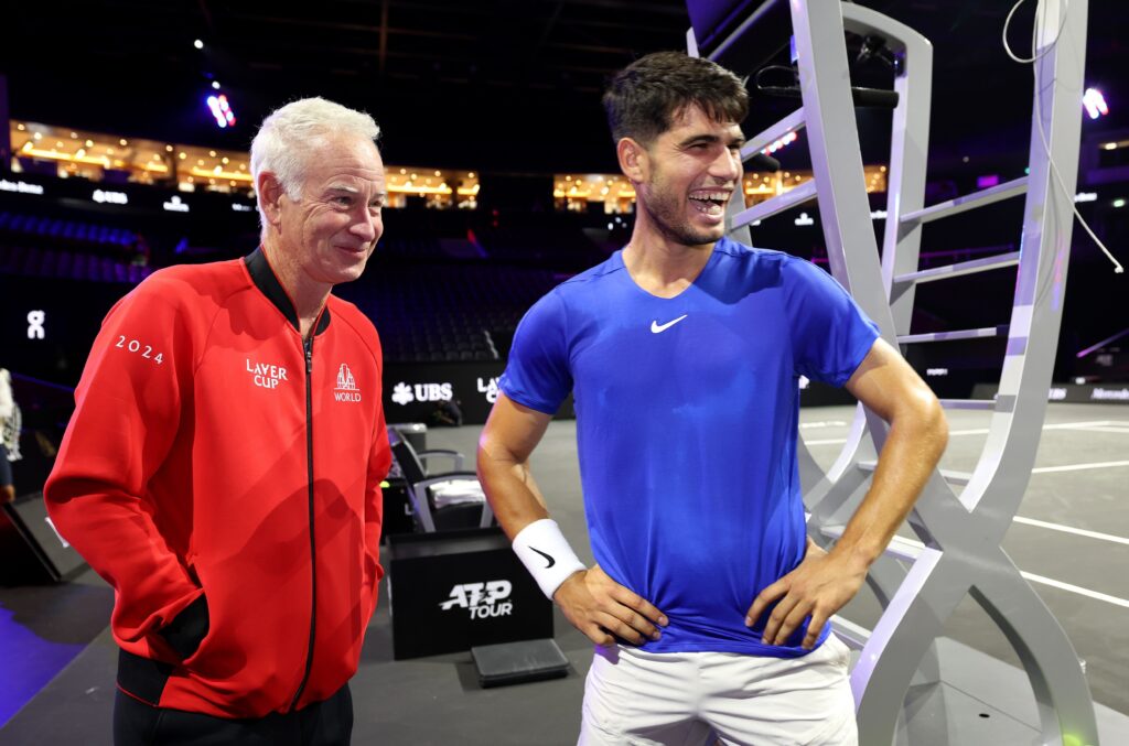 John McEnroe, Captain of Team World and Carlos Alcaraz of Team Europe react on the court ahead of Laver Cup at Uber Arena on September 18, 2024 in Berlin, Germany.