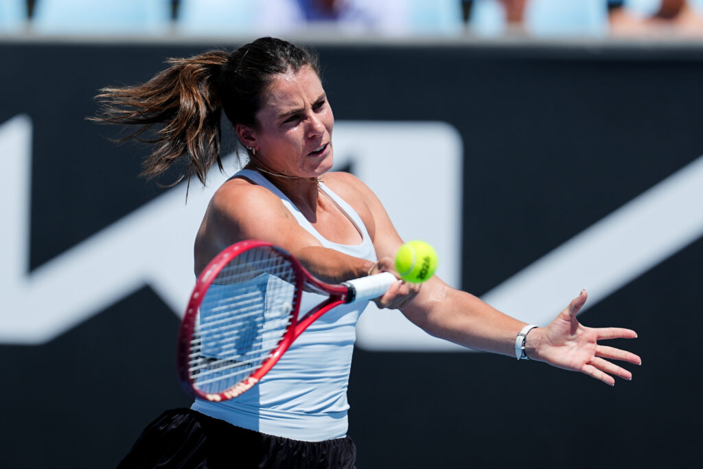 Emma Navarro of the United States plays a forehand in the Women's Singles First Round match against Magda Linette of Poland during day two of the 2026 Australian Open at Melbourne Park on January 19, 2026 in Melbourne, Australia.
