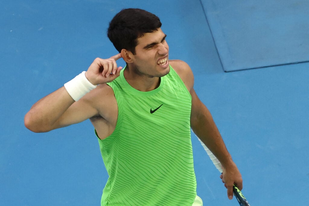 Spain's Carlos Alcaraz gestures to the crowd after winning a point against Germany's Alexander Zverev during their men's singles semi-final match on day thirteen of the Australian Open tennis tournament in Melbourne on January 30, 2026.