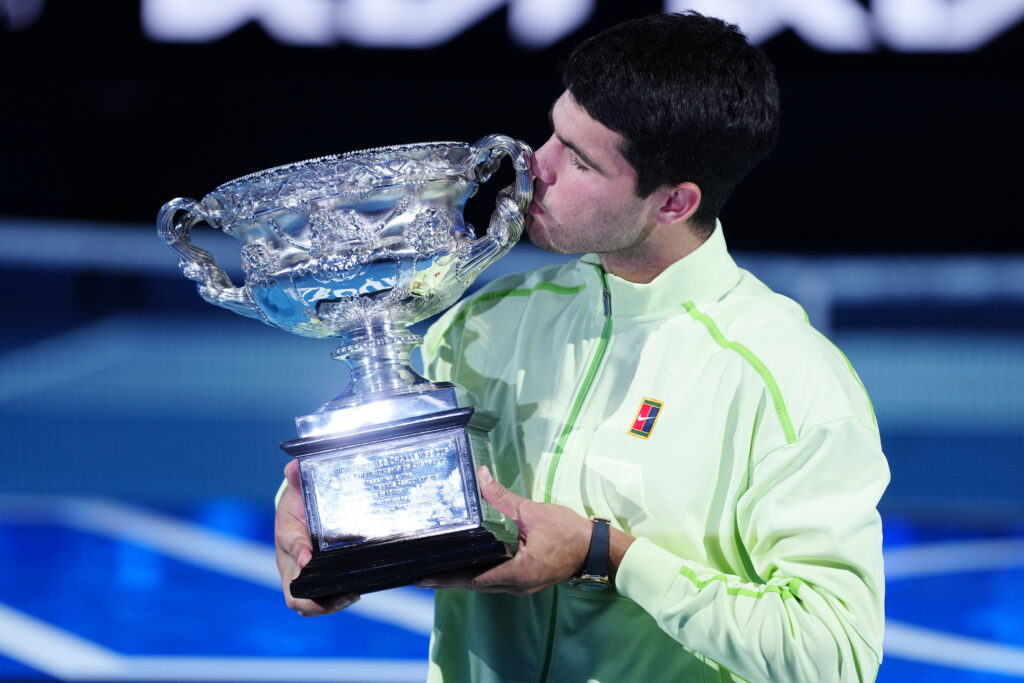 Carlos Alcaraz of Spain poses with the Norman Brookes Challenge Cup during the official presentation after defeating their Men's Singles Final match against Novak Djokovic of Serbia during day 15 of the 2026 Australian Open at Melbourne Park on February 1, 2026 in Melbourne, Australia.