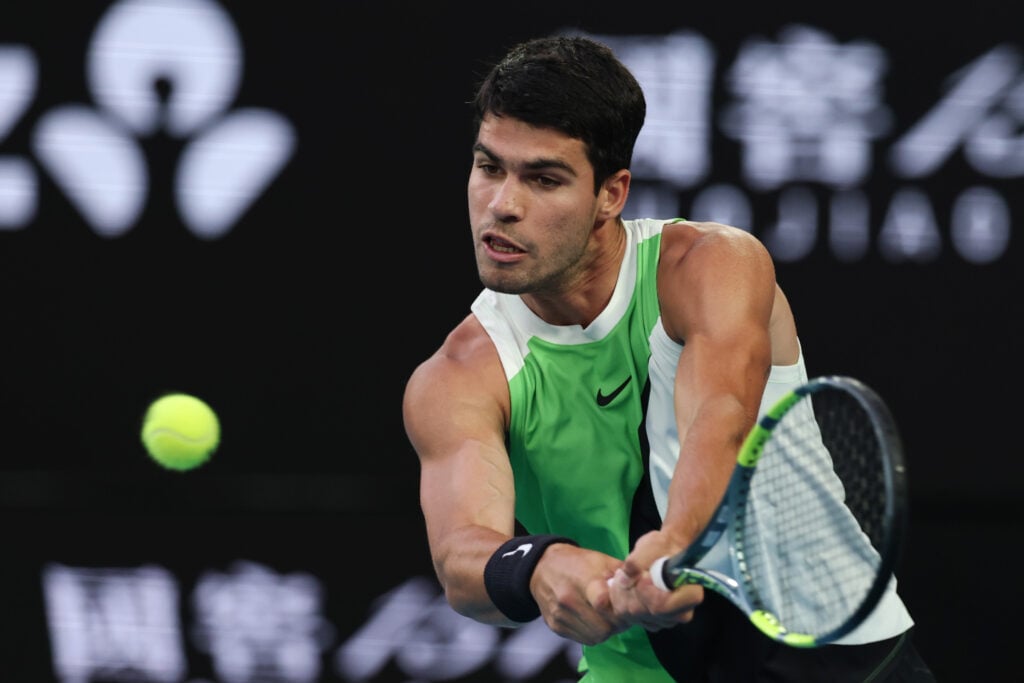 Carlos Alcaraz of Spain plays a backhand in the Men's Singles Final against Novak Djokovic of Serbia during day 15 of the 2026 Australian Open at Melbourne Park on February 01, 2026 in Melbourne, Australia.