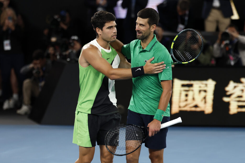 Carlos Alcaraz and Novak Djokovic walk arm in arm