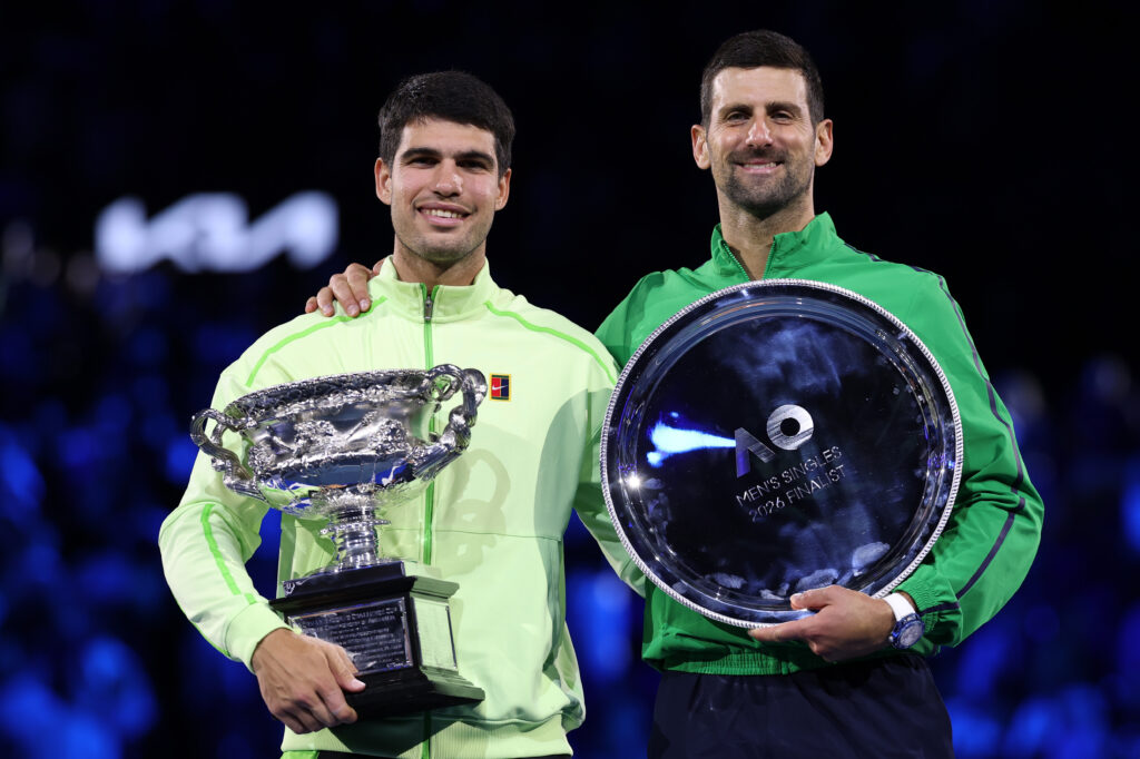 Winner Carlos Alcaraz of Spain and runner-up Novak Djokovic of Serbia pose at the presentation ceremony after the Men's Singles Final during day 15 of the 2026 Australian Open at Melbourne Park on February 01, 2026 in Melbourne, Australia.