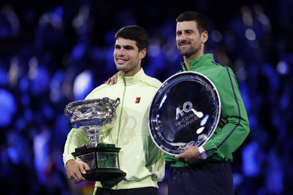 Winner Carlos Alcaraz of Spain and runner-up Novak Djokovic of Serbia pose at the presentation ceremony after the Men's Singles Final during day 15 of the 2026 Australian Open at Melbourne Park on February 01, 2026 in Melbourne, Australia.