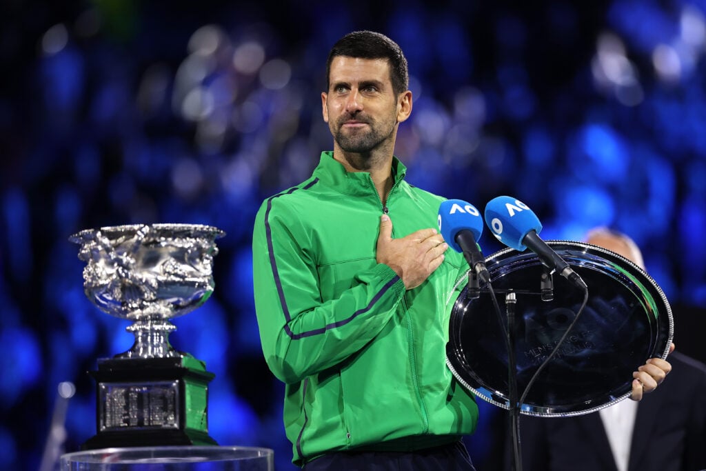Runner-up Novak Djokovic of Serbia speaks with the finalist plaque at the presentation ceremony after the Men's Singles Final against Carlos Alcaraz of Spain during day 15 of the 2026 Australian Open at Melbourne Park on February 01, 2026 in Melbourne, Australia.