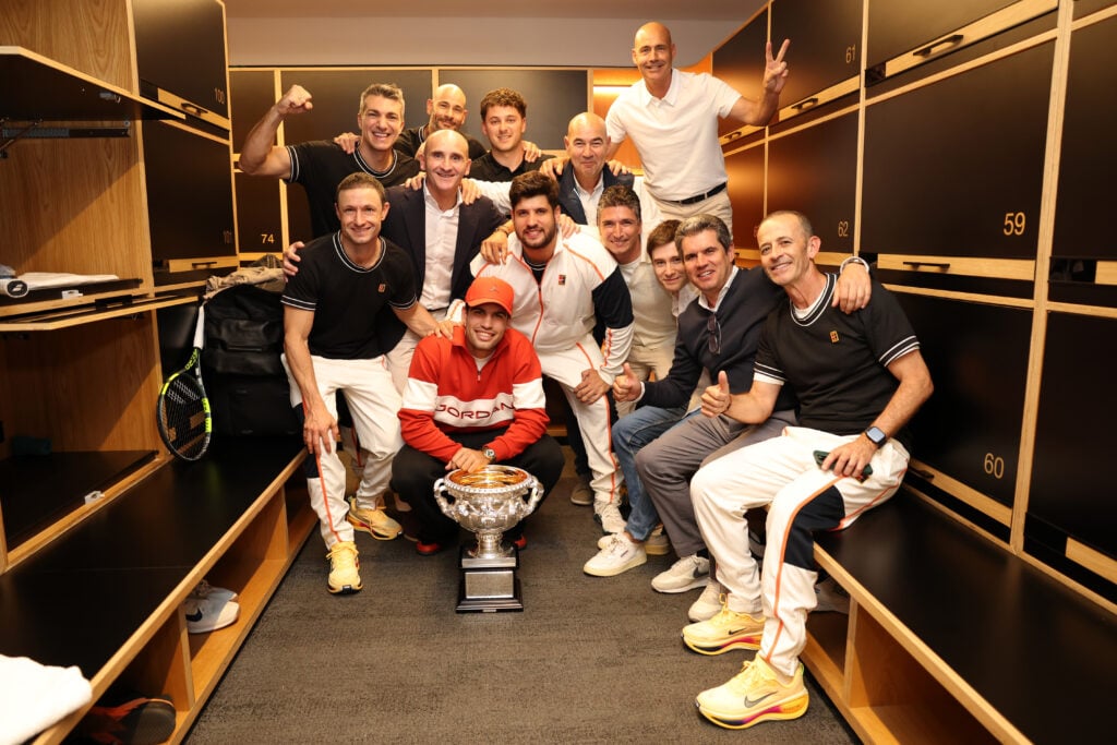 Carlos Alcaraz of Spain poses with the Norman Brookes Challenge Cup in the locker room with his coaching staff and family members after winning the Men's Singles Final against Novak Djokovic of Serbia during day 15 of the 2026 Australian Open at Melbourne Park on February 02, 2026 in Melbourne, Australia.