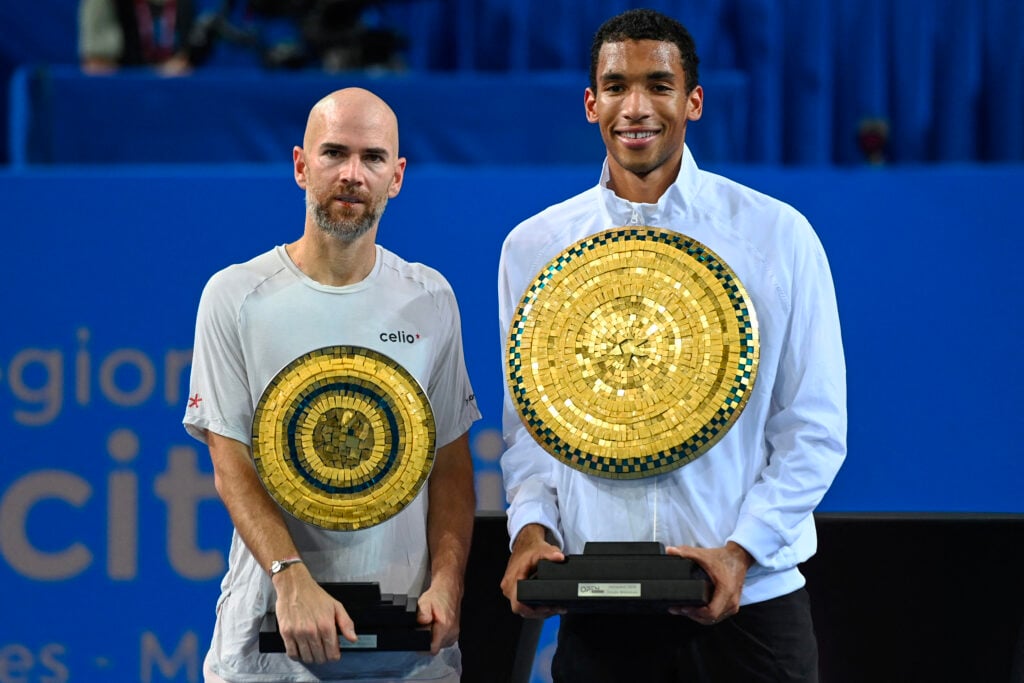 France's Adrian Mannarino (L) and winner Canada's Felix Auger Aliassime pose with their trophies after Auger Aliassime won their ATP World Tour Open Occitanie final tennis match in Montpellier, southern France on February 8, 2026.