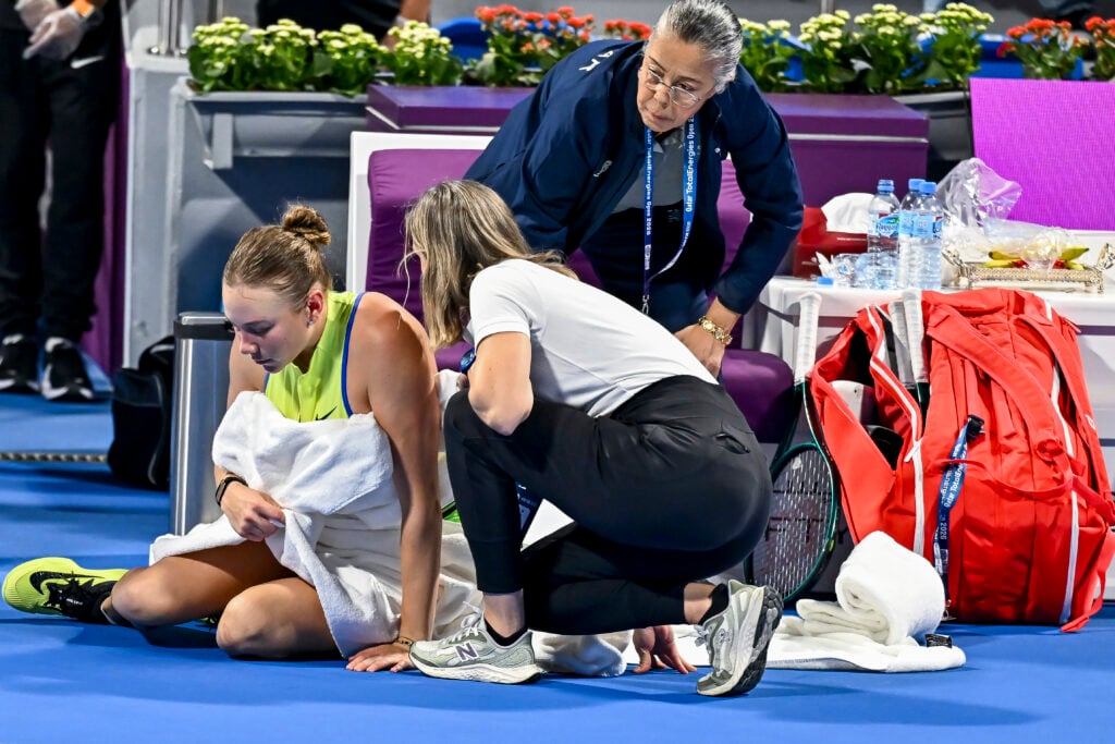 Amanda Anisimova of the United States receives medical assistance during round of 32 match against Karolina Pliskova of the Czech Republic (not pictured) at the WTA Qatar TotalEnergies Open 2026 tennis tournament at the Khalifa International Tennis Complex. Karolina Pliskova won the match after Amanda Anisimova retired, with the score 7-5, 6-7, 4-1.