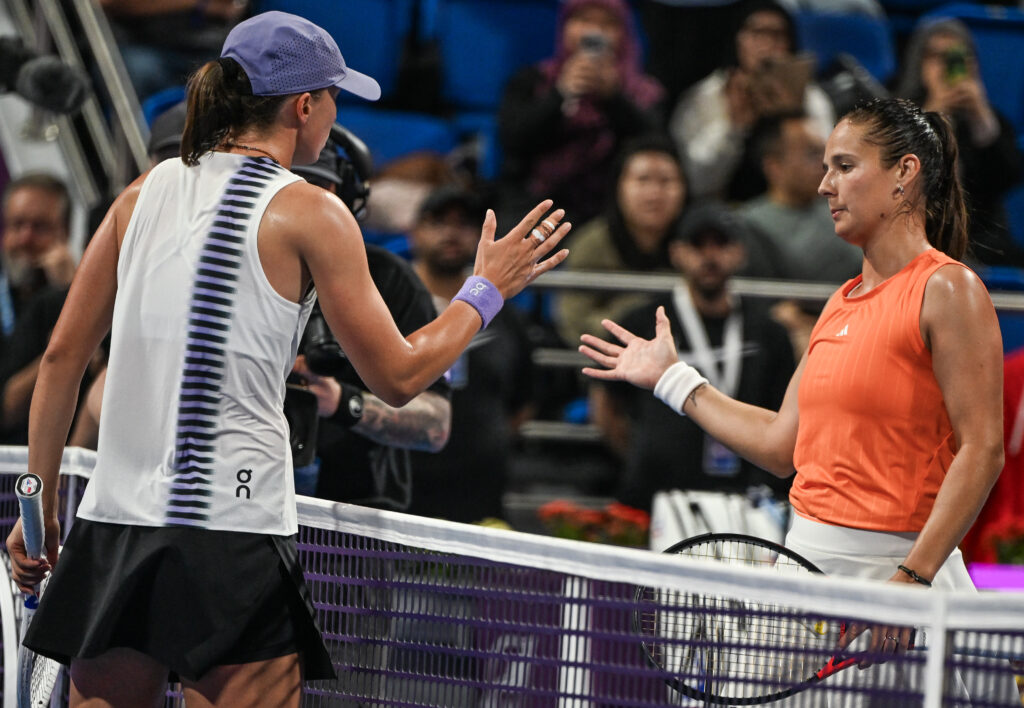 Iga Swiatek of Poland shakes hands with Daria Kasatkina of Australia iat the end of their match n the Round of 16 on Day Four of the Qatar TotalEnergies Open