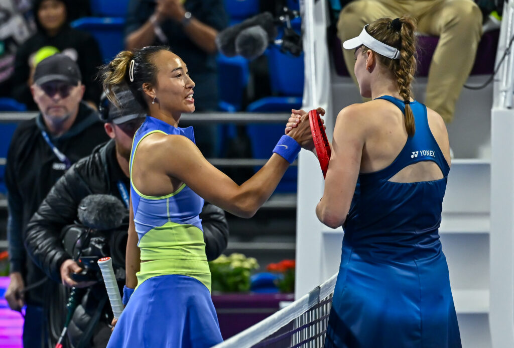 Elena Rybakina of Kazakhstan shakes hands with Qinwen Zheng of China after winning the round of 16 match against Qinwen Zheng of China at the WTA Qatar TotalEnergies Open 2026 tennis tournament at the Khalifa International Tennis Complex in Doha, Qatar, on February 11, 2026.