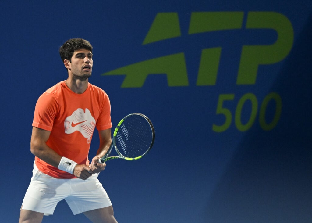 Carlos Alcaraz of Spain is seen during a practice session with Stefanos Tsitsipas of Greece ahead of the Qatar ExxonMobil Open at the Khalifa International Tennis and Squash Complex on February 16, 2026 in Doha, Qatar.