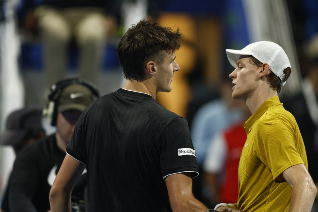 Czech Republic's Jakub Mensik (L) is congratulated by Italy's Jannik Sinner after winning the men's singles quarterfinal match at the Qatar Open tennis tournament in Doha on February 19, 2026.