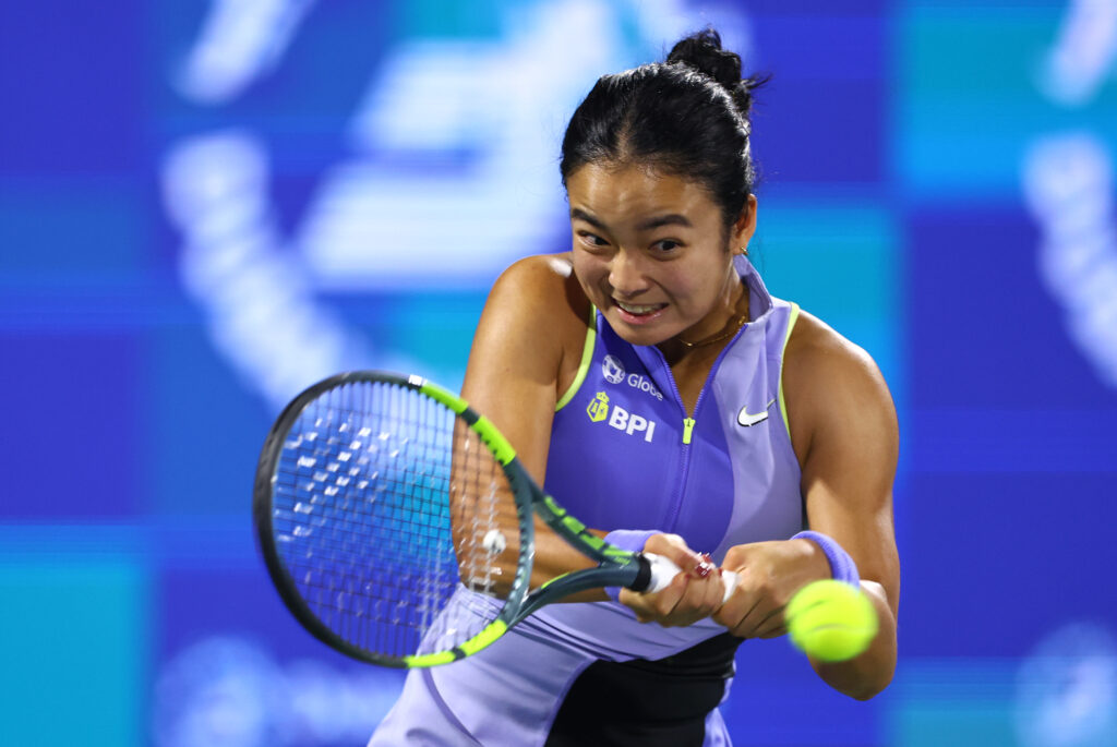 Alexandra Eala of Philippines plays a backhand against Jasmine Paolini of Italy during her women's singles match on day three of the Dubai Duty Free Tennis Championships, part of the Hologic WTA Tour at Dubai Duty Free Tennis Stadium on February 17, 2026 in Dubai, United Arab Emirates.