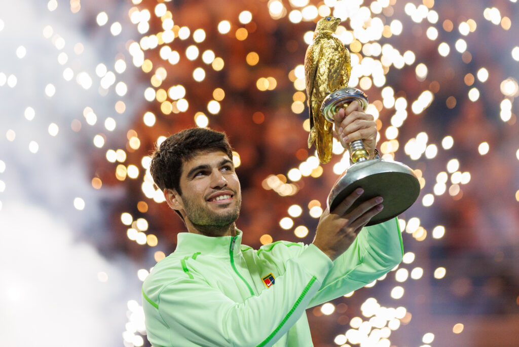 Carlos Alcaraz of Spain celebrates with the trophy after winning his men's singles final match against Arthur Fils of France at the Qatar ExxonMobil Open at Khalifa International Tennis and Squash Complex on February 21, 2026 in Doha, Qatar.